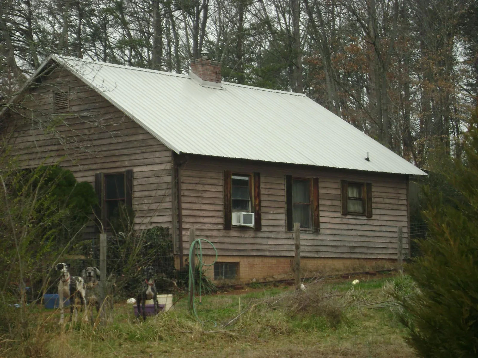 White metal roof on an old wood sided farmhouse, from a Metal Roof Installation job in Brogue